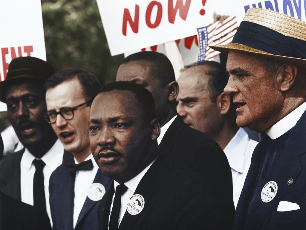 Martin Luther King Jr. standing with other protesters. 
